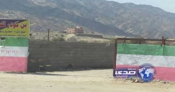 وافدون يطلون جداراً بعلم إيران في المجاردة والبلدية تزيله