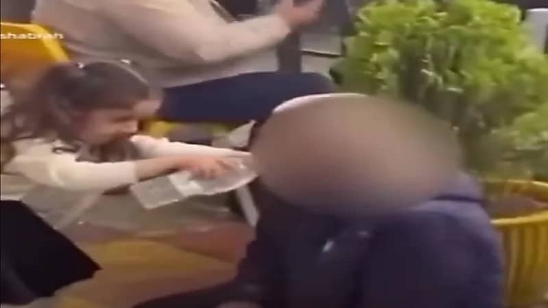 شاهد.. طفلة تسقي مشرداً الماء في فمه وتخطف القلوب ببرائتها